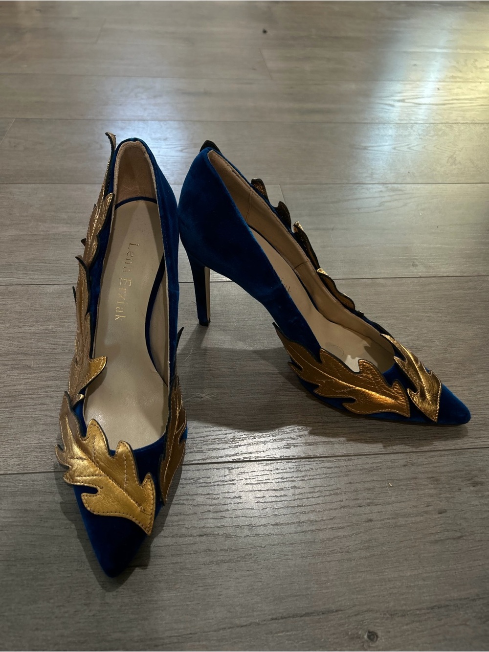 Lena Erziak
Size: EU 39
Blue Velvet Pumps with Gold Leaf Accents
